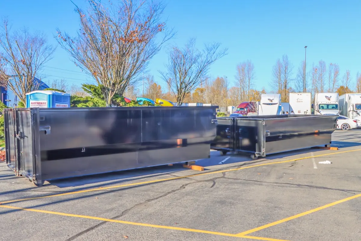 Professional dumpster rental service with roll-off container on residential driveway in Littleton